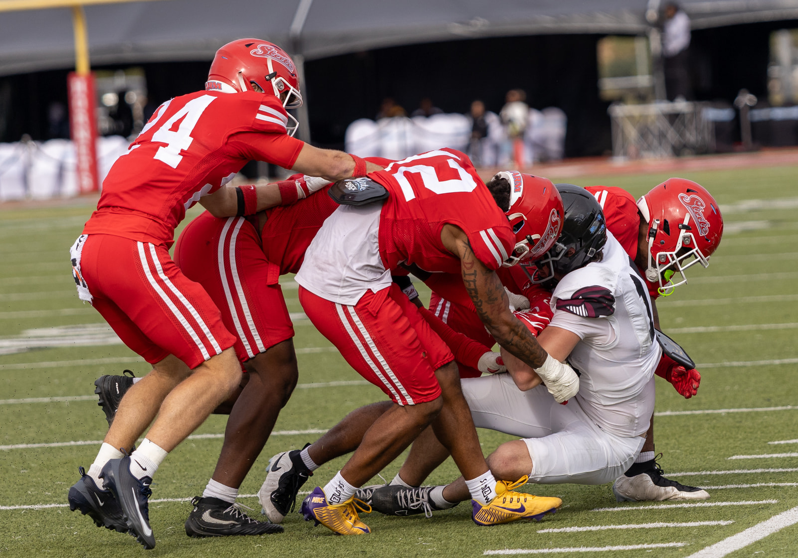 Delaware State defenders gang-tackle a Franklin Pierce ball carrier