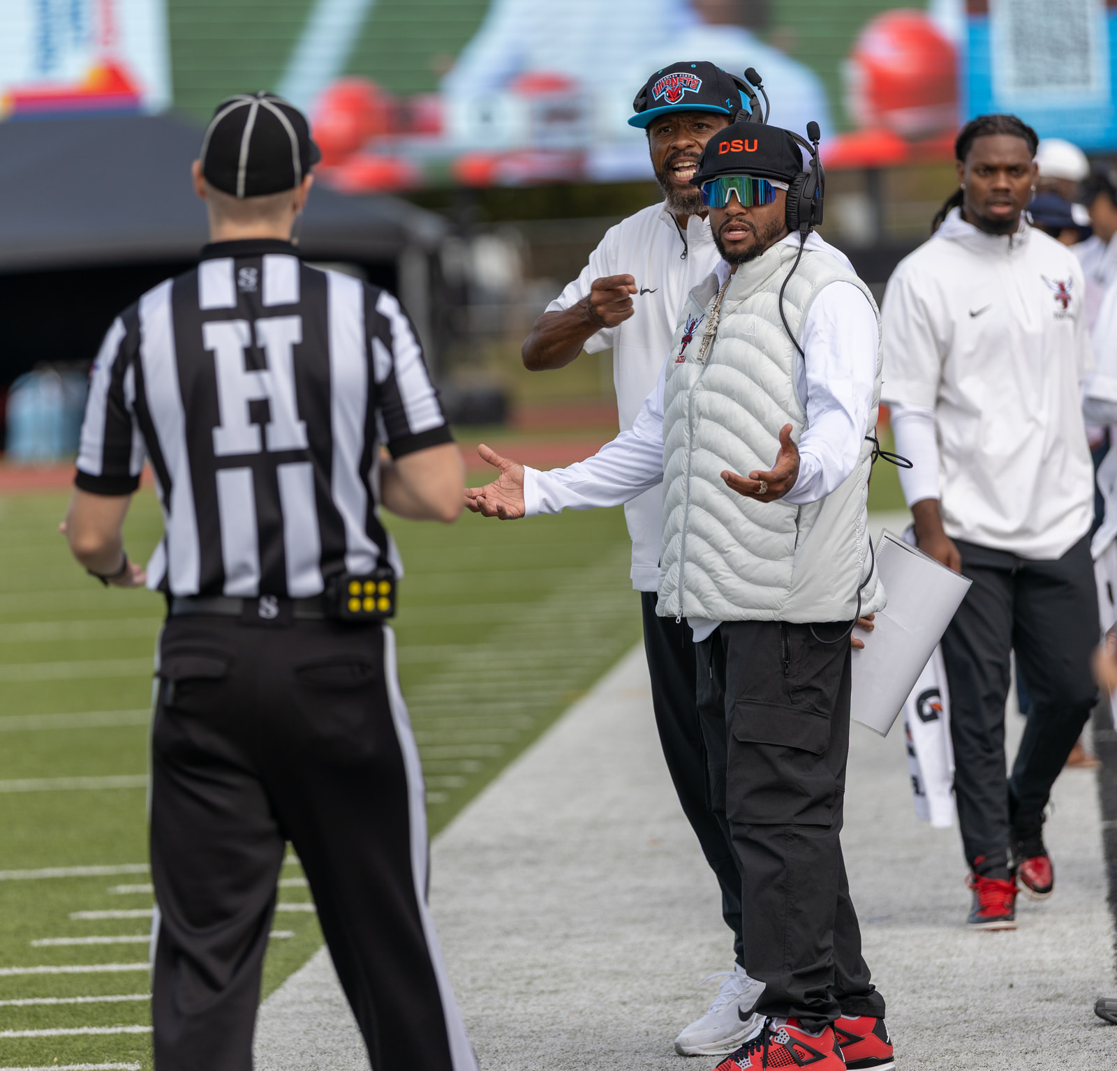 Delaware State head coach DeSean Jackson makes his case to the head linesman on the sideline