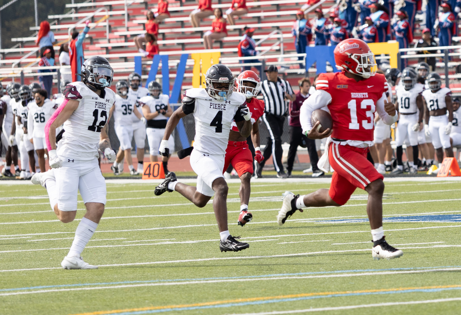Jayden Sauray runs clear of two Franklin Pierce defenders in the open field
