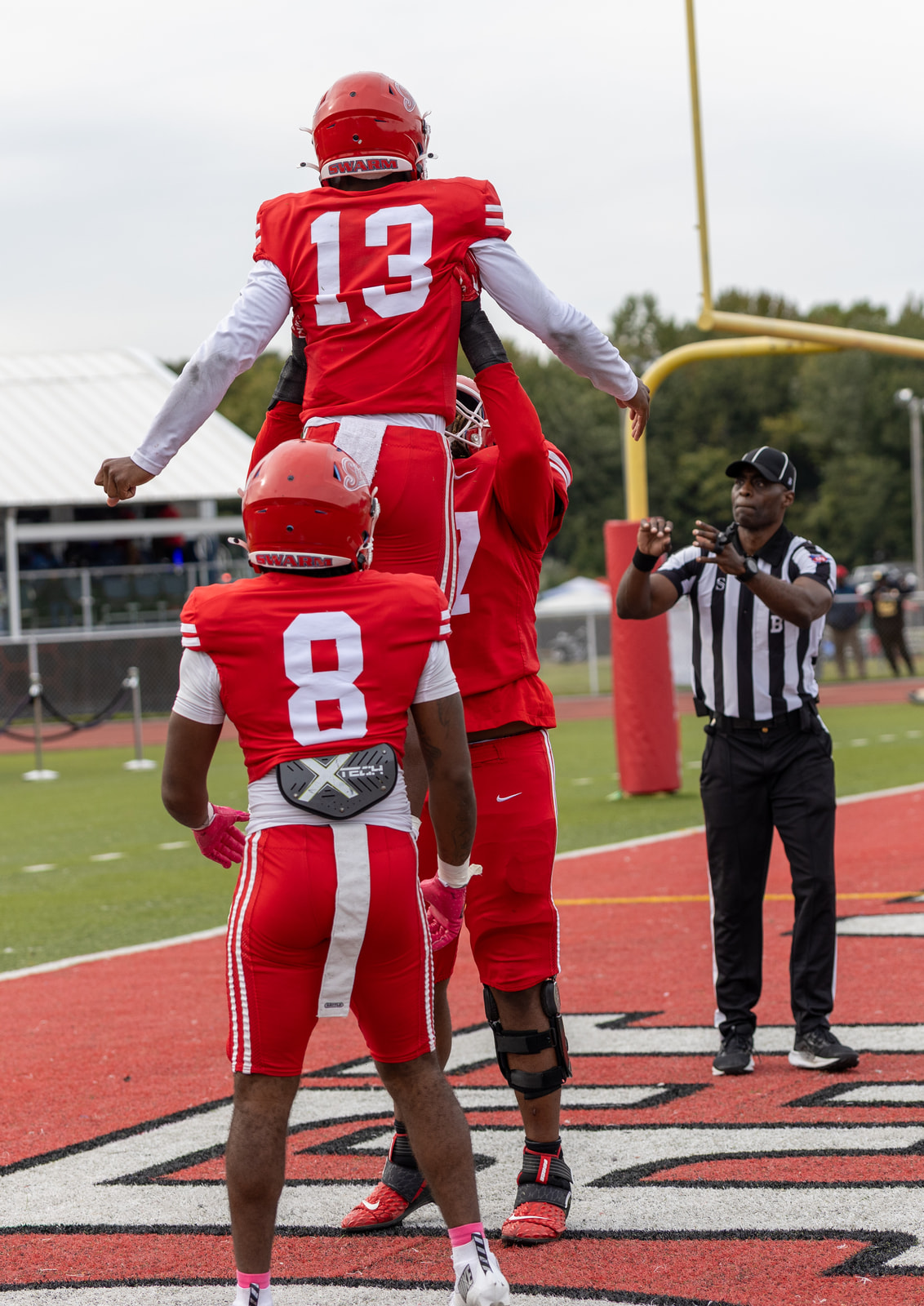 Teammates lift Jayden Sauray in the end zone at Alumni Stadium