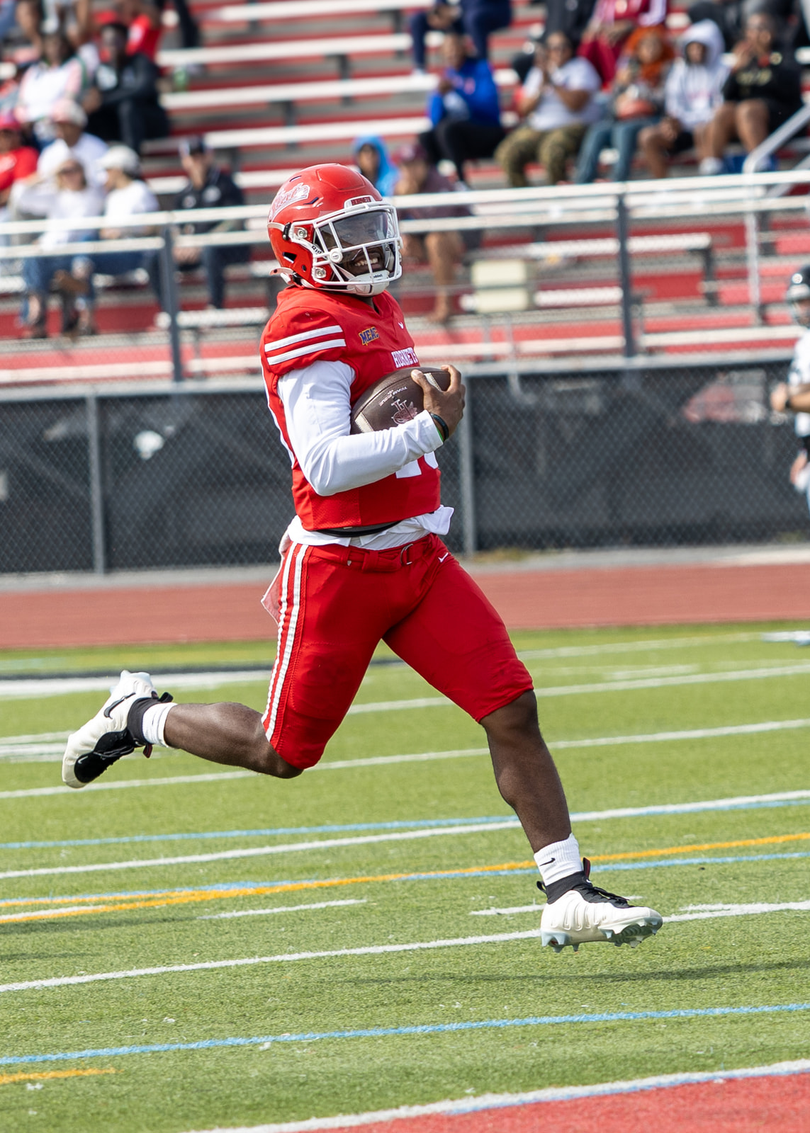 Jayden Sauray runs untouched up the field with the ball in his left arm